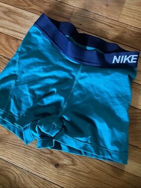 Nike Teal Compression Shorts with Navy Waistband and White Swoosh